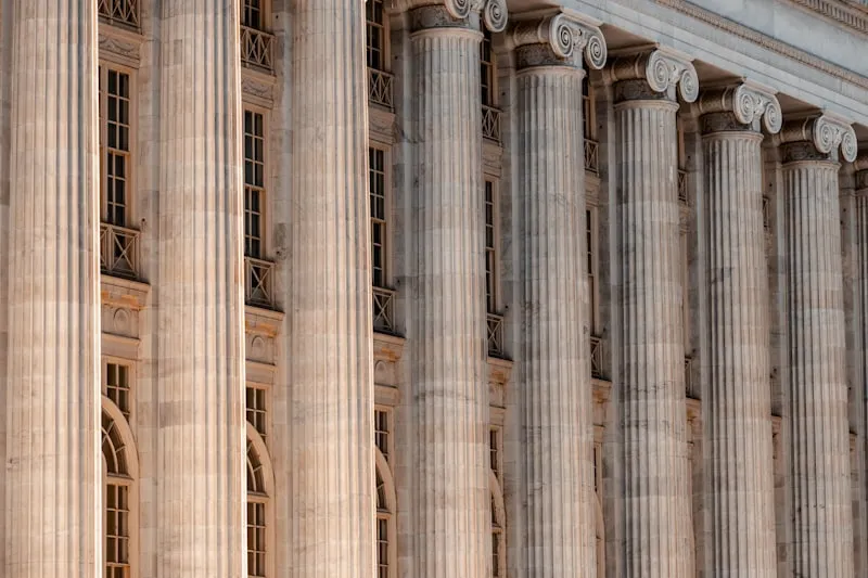 Classical government building columns representing governance and institutions