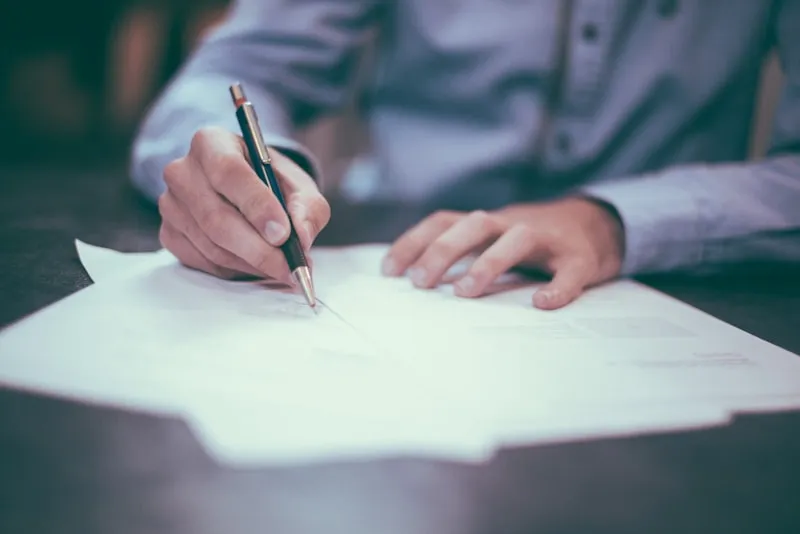 Professional reviewing and signing a proposal document