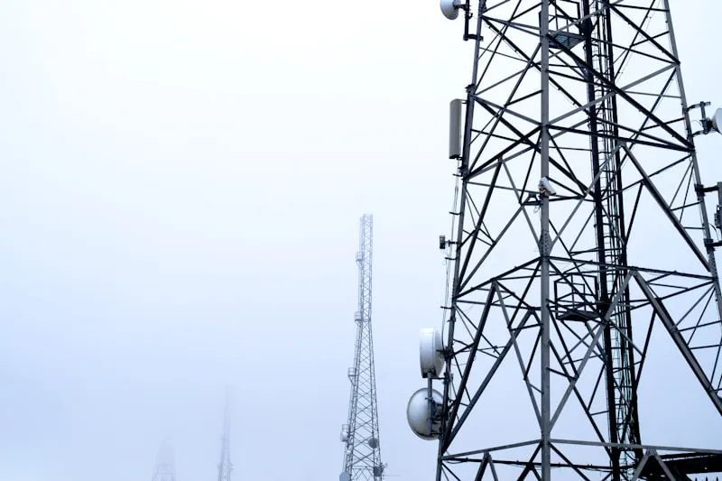 Telecommunications towers against a cloudy sky